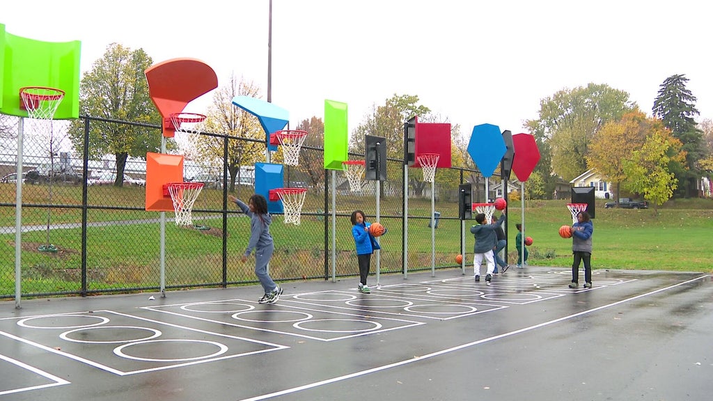 Children and families enjoying the newly renovated Cleveland Park in North Minneapolis on a sunny autumn day.
